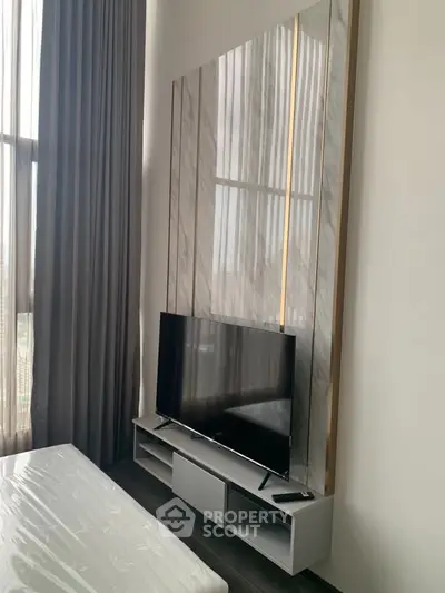 Modern living room with high ceilings and sleek TV setup