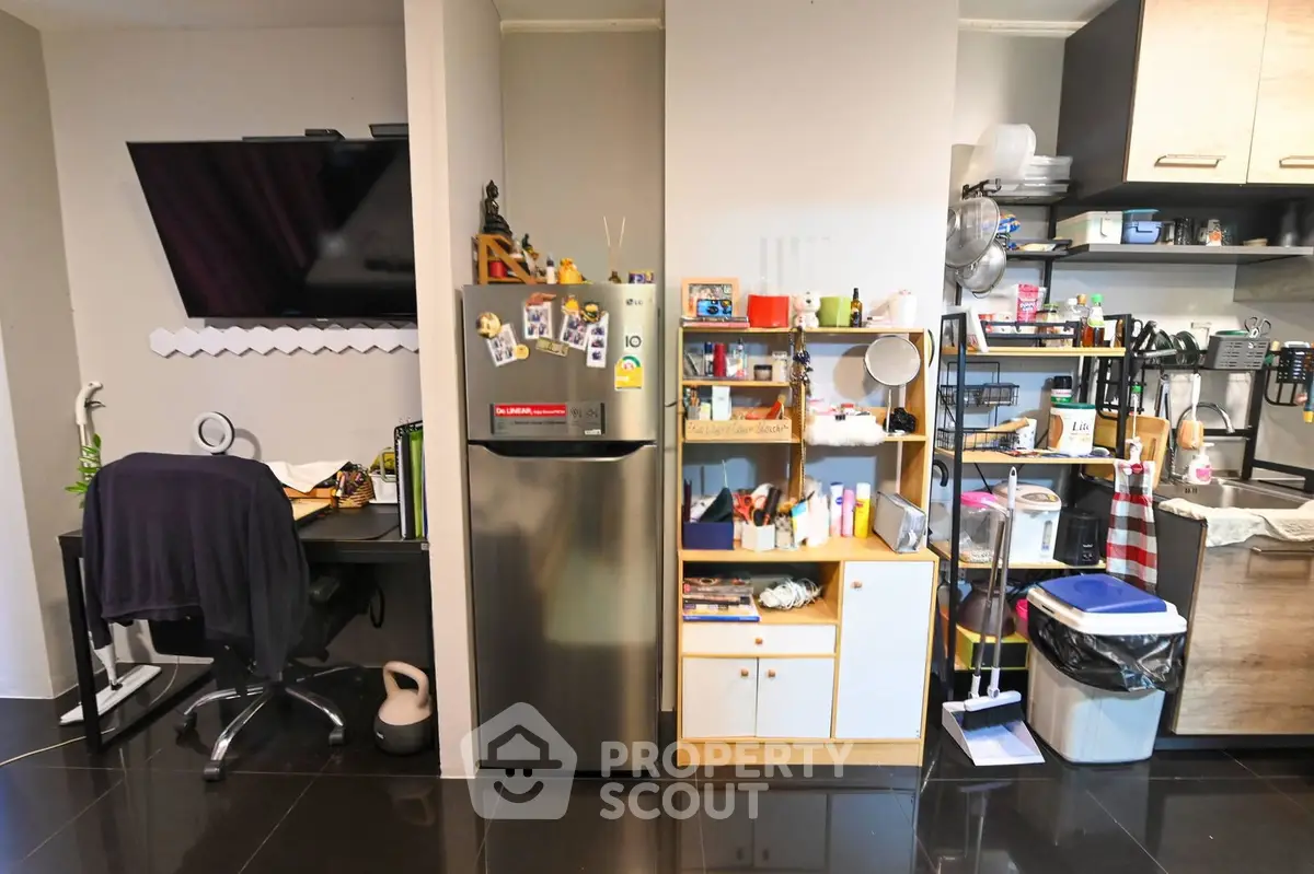Compact kitchen and study area with modern appliances and organized shelving