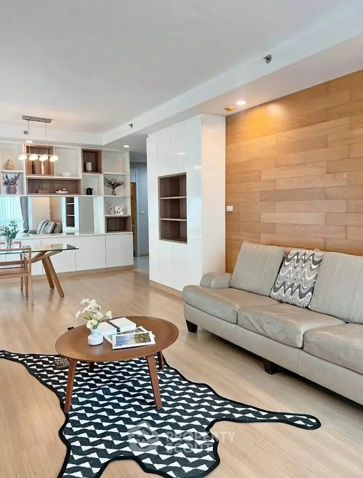 Modern living room with stylish decor and open layout, featuring a cozy sofa and chic coffee table.