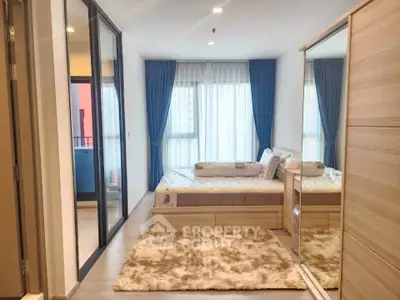 Modern bedroom with large windows and stylish decor in a contemporary apartment.