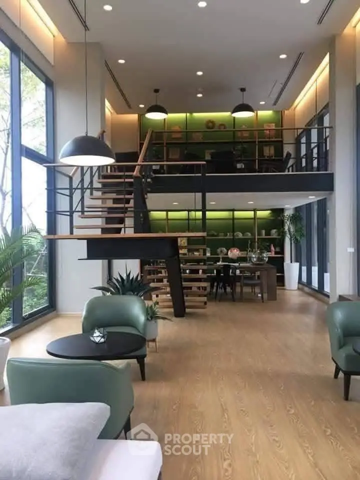 Stunning modern living room with high ceilings, mezzanine, and large windows offering natural light.