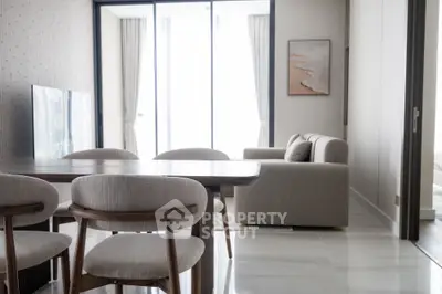 Modern living room with elegant dining area and natural light