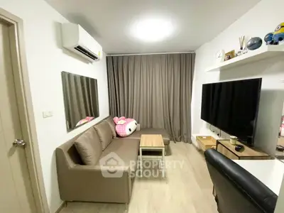 Modern living room with cozy sofa, large TV, and stylish decor in a contemporary apartment.