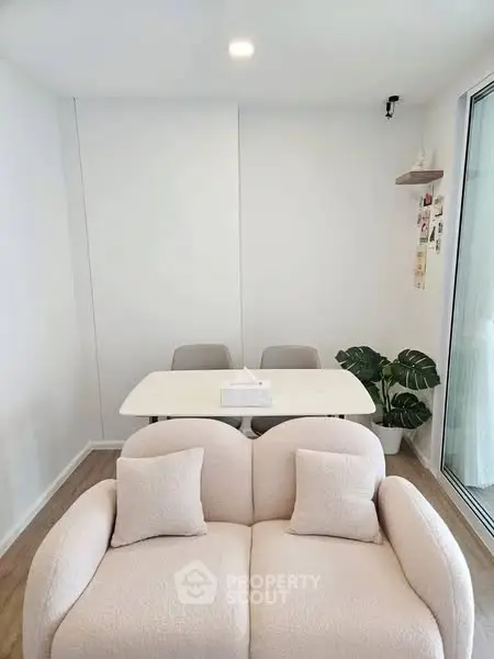 Chic modern living room with cozy sofa and elegant dining area, perfect for urban lifestyle.
