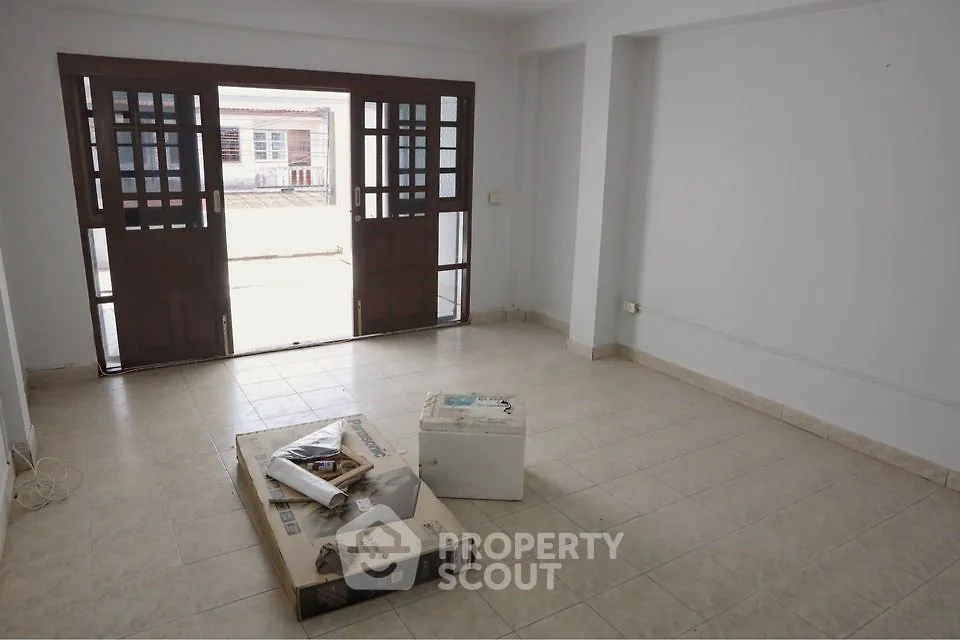 Spacious empty room with large windows and tiled floor, perfect for customization.
