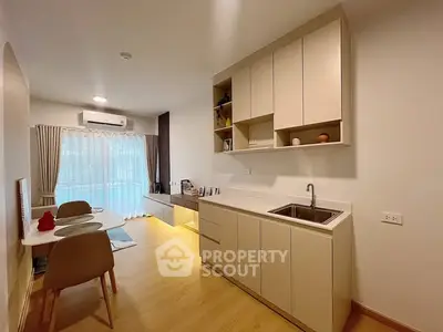Modern open-layout kitchen with dining area and natural light