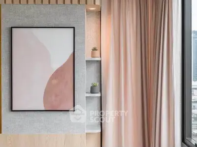 Stylish modern interior with elegant wall art and soft drapery in a cozy living space.