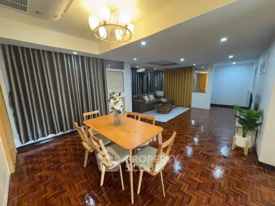 Spacious modern living room with elegant dining area and stylish wooden flooring.