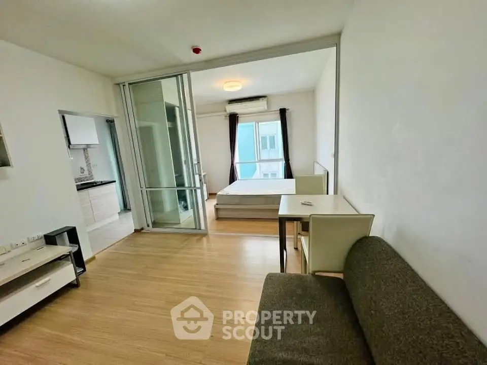 Modern studio apartment with open layout and wooden flooring