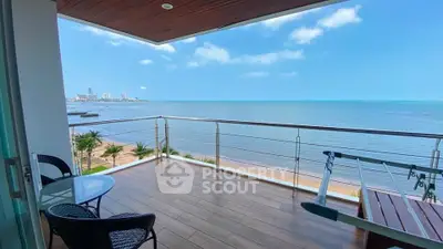 Stunning ocean view from spacious balcony with seating area and exercise equipment.