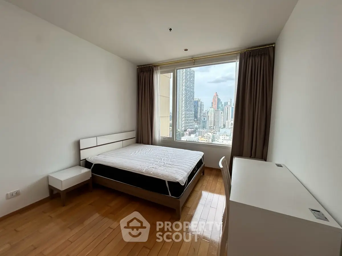 Spacious bedroom with city view in modern apartment