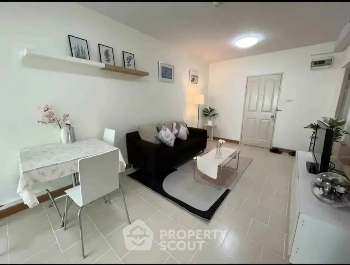 Charming living room with modern decor and cozy seating area in a stylish apartment.