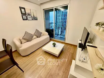 Modern living room with cozy sofa and city view balcony, perfect for urban living.