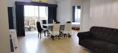 Spacious living and dining area with elegant furniture and natural light