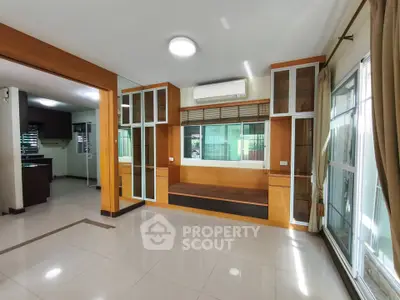 Spacious modern living room with large windows and built-in seating area