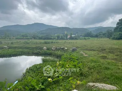 Scenic land plot with lush greenery and mountain views, ideal for development or investment.