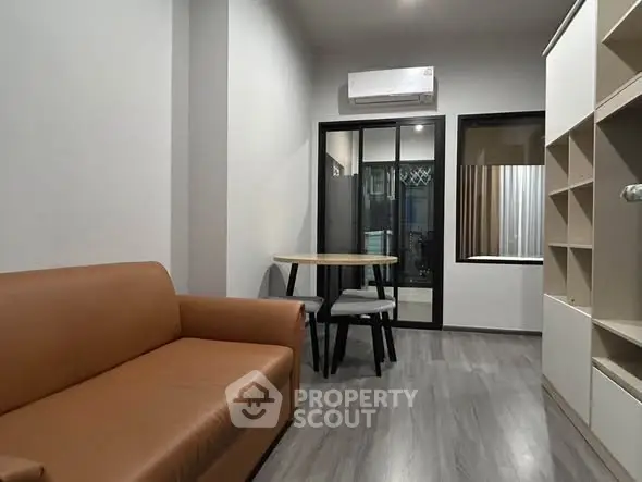 Modern living room with sleek furniture and air conditioning in a stylish apartment.