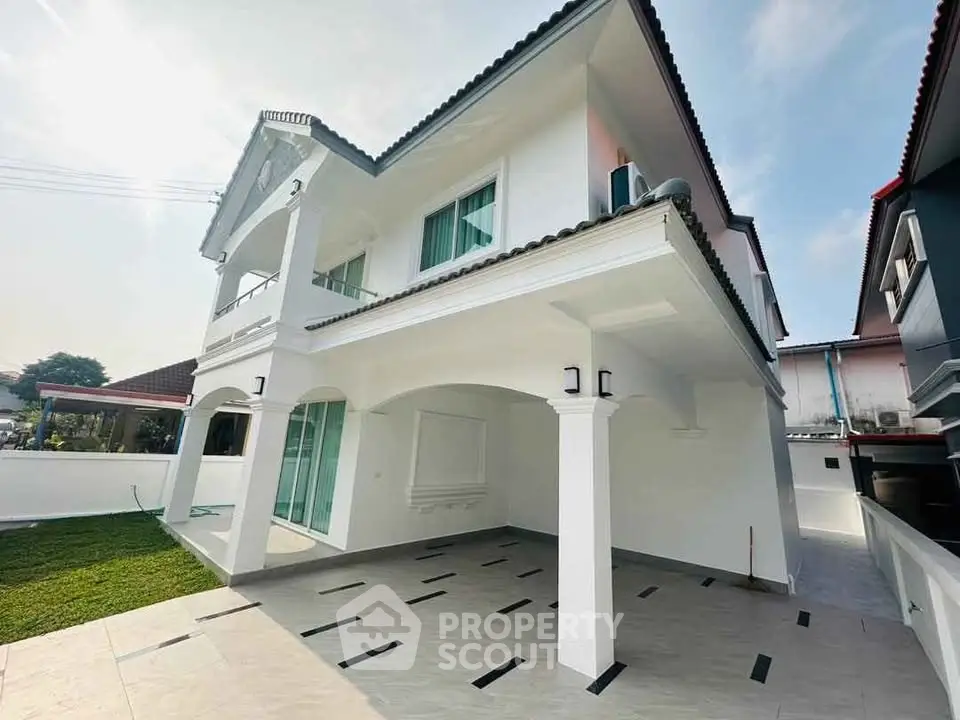 Stunning two-story white house with spacious driveway and lush green lawn, perfect for family living.
