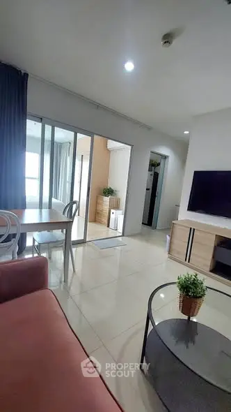 Modern living room with sleek furniture and natural light, perfect for urban living.