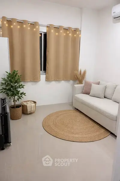 Cozy living room with beige sofa, round rug, and decorative plants