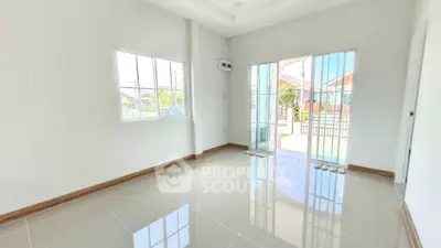 Bright and airy room with large windows and glossy tiled floor, perfect for modern living.