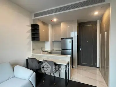 Modern open-layout kitchen with sleek design and cozy dining area