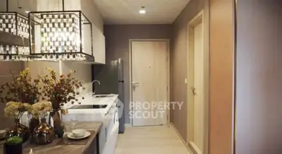 Modern kitchen with sleek design and elegant lighting in a stylish apartment.