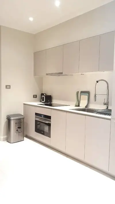 Modern kitchen with sleek cabinetry and built-in appliances in a contemporary apartment.