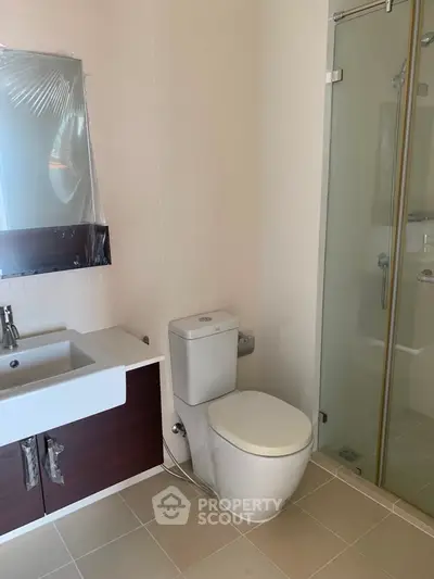 Modern bathroom with sleek fixtures and glass shower enclosure