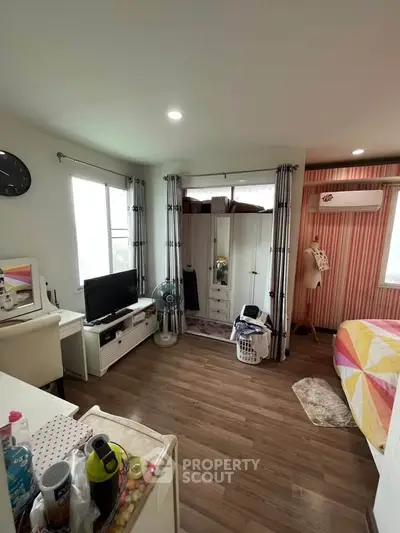 Cozy bedroom with modern decor and ample natural light