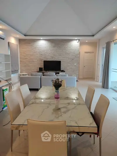 Spacious living room with modern dining area and stylish decor