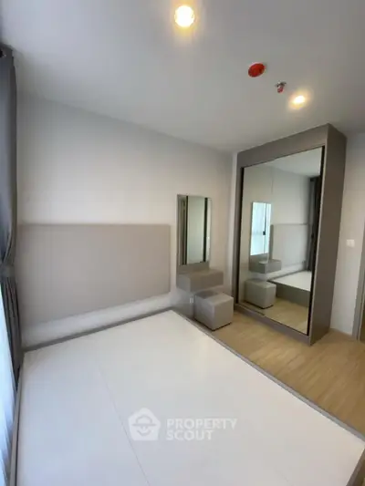 Modern bedroom with mirrored wardrobe and minimalist decor