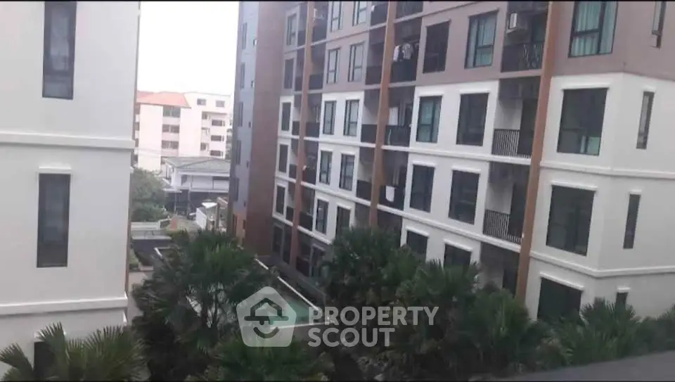 Modern apartment building with lush greenery and urban view