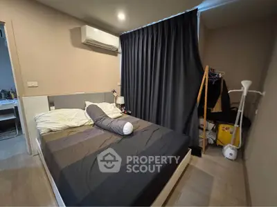 Cozy bedroom with modern air conditioning and stylish decor, perfect for comfortable living.