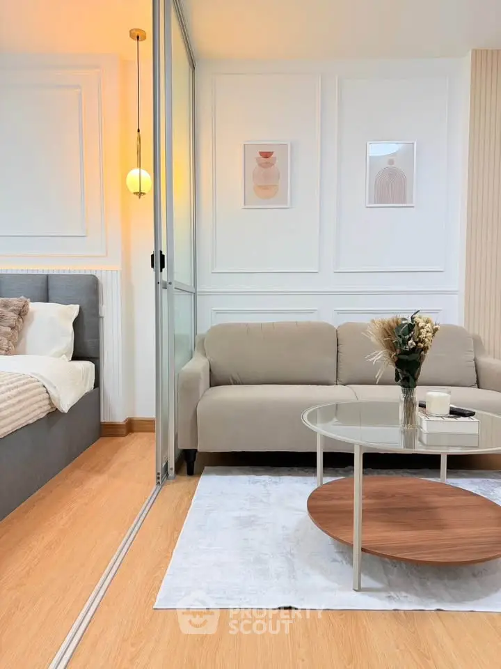 Modern living room with stylish decor and cozy ambiance, featuring a comfortable sofa and elegant wall art.