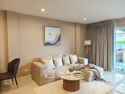 Elegant living room with modern decor and natural light, featuring a cozy sofa and stylish coffee table.