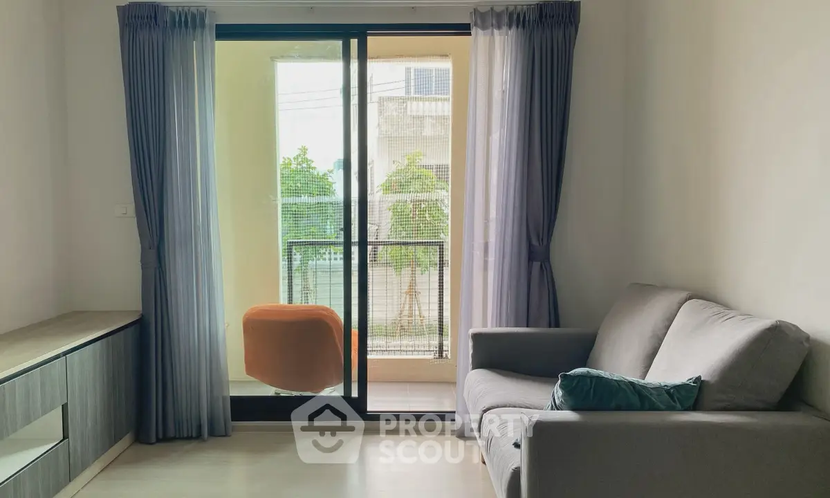 Cozy living room with balcony access and modern furnishings in a bright apartment.