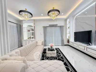 Luxurious living room with elegant chandeliers and plush seating in a modern home.