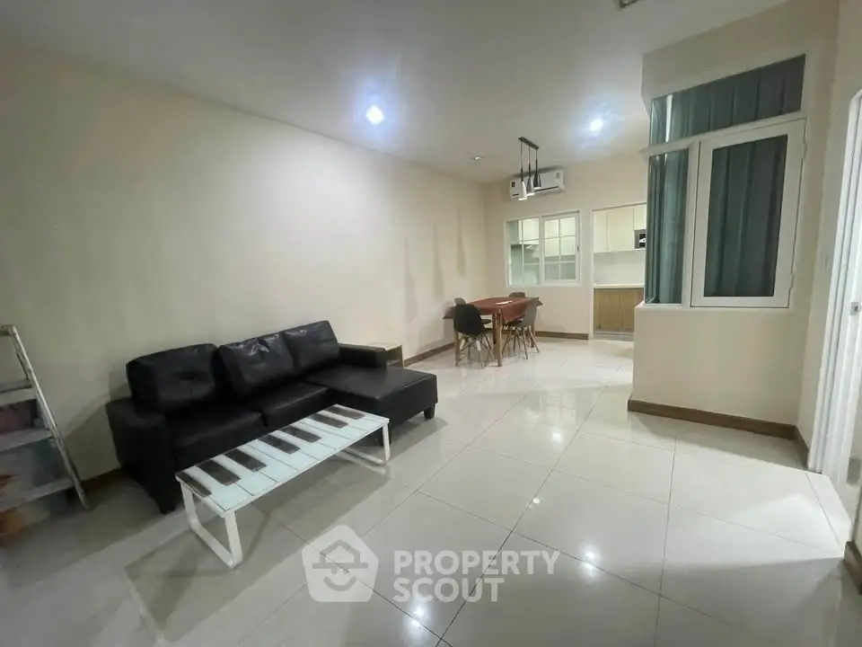 Spacious living room with modern furniture and open kitchen layout