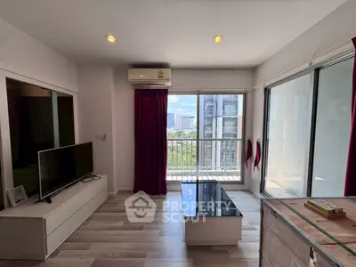 Modern living room with city view, featuring sleek furniture and large windows for natural light.