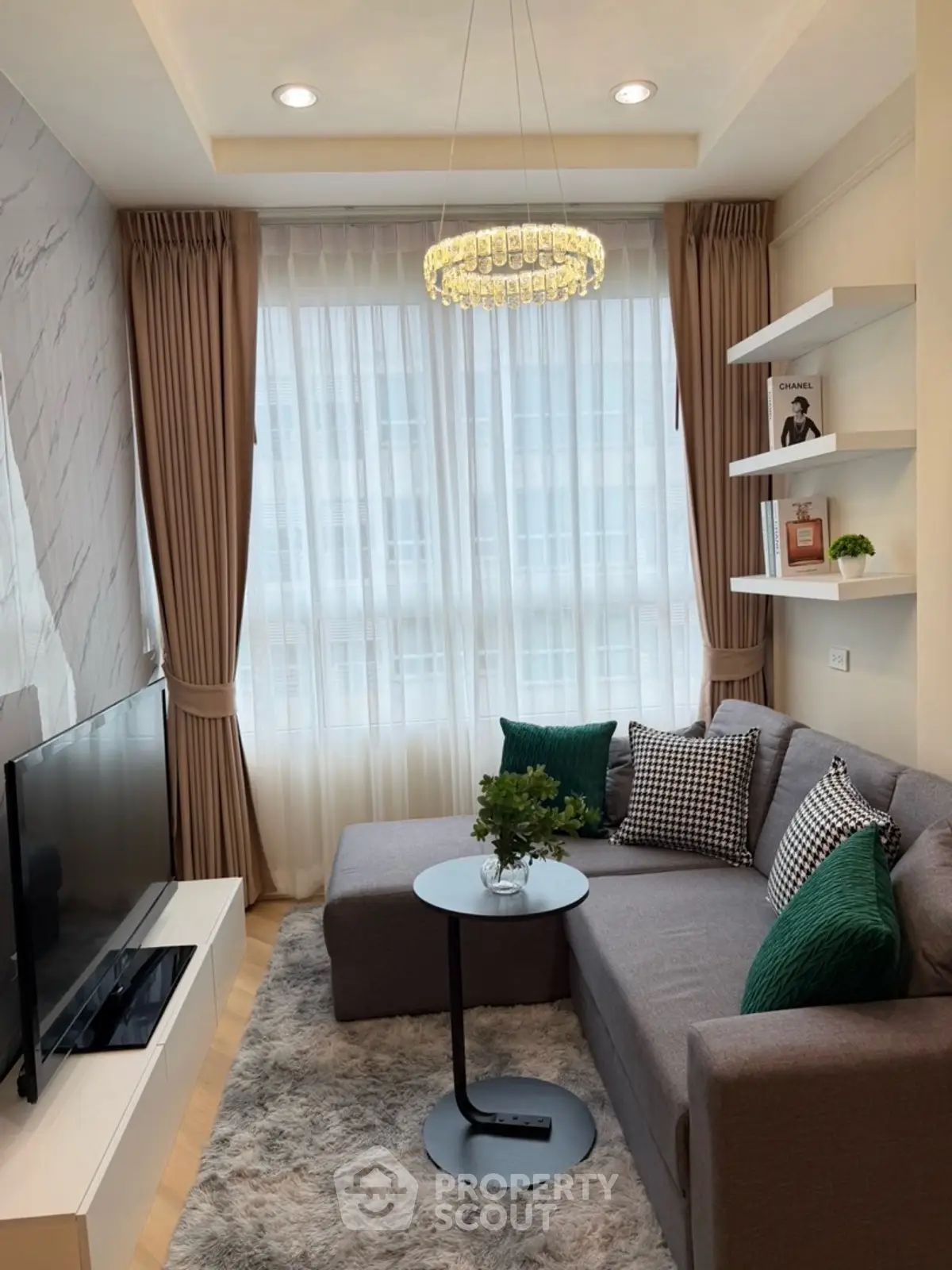 Stylish living room with modern decor, cozy sofa, and elegant lighting.