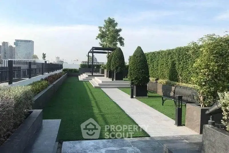 Luxurious rooftop garden with lush greenery and modern seating area.