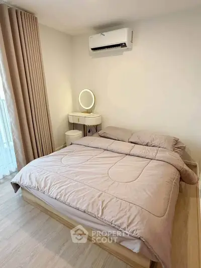 Cozy bedroom with modern decor and air conditioning, perfect for relaxation.
