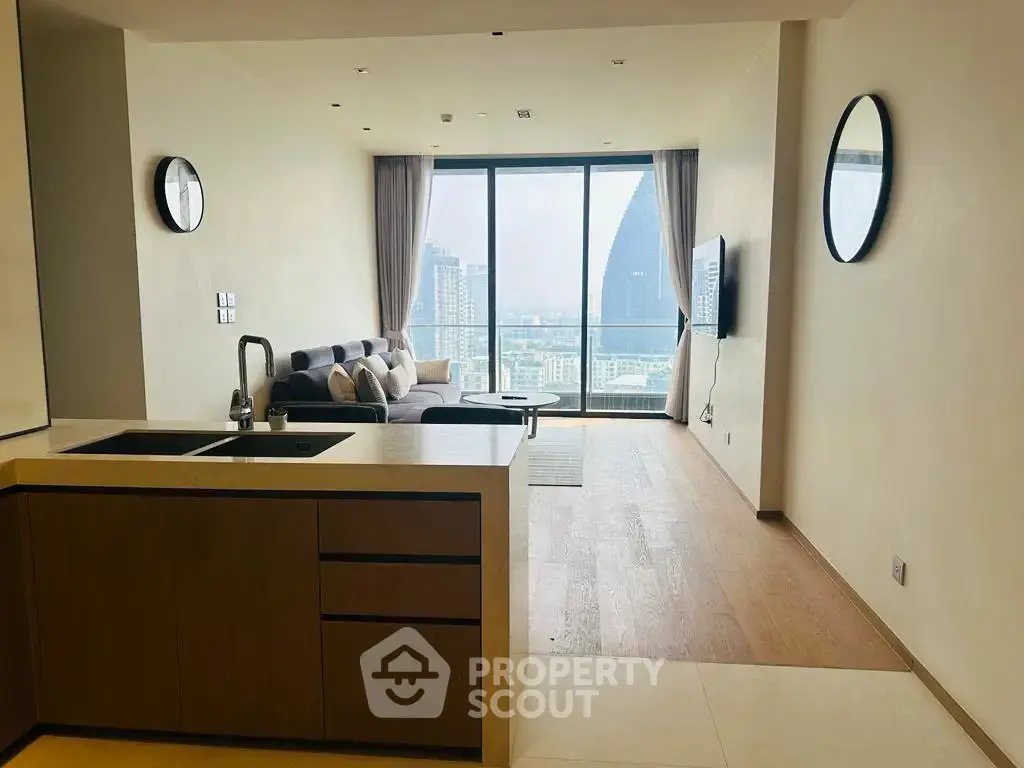 Modern open-plan living room with stunning city view and sleek kitchen design.