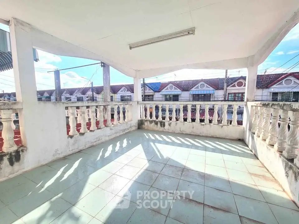 Spacious balcony with scenic neighborhood view, perfect for relaxation and outdoor activities.