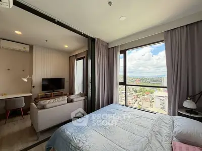 Modern studio apartment with large windows offering stunning city views and stylish interior design.