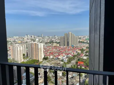 Stunning cityscape view from a high-rise balcony showcasing urban skyline and residential areas.