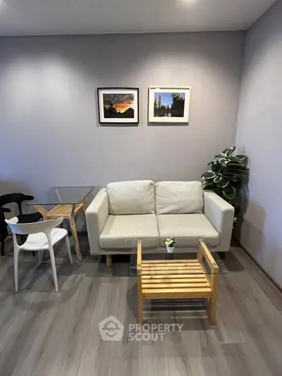 Modern living room with stylish furniture and decor, featuring a cozy sofa and elegant wooden flooring.