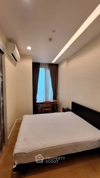 Cozy bedroom with modern furnishings and natural light