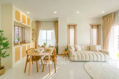 Elegant open-plan living and dining area with modern furniture and natural light.